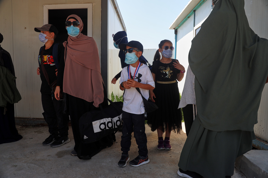 Members of Australian families at Roj Camp in eastern Syria, housing people with alleged ties to Islamic State militants, prepare to leave for Damascus as part of a second repatriation effort by Syrian authorities, at Roj Camp in eastern Syria, Friday, April 24, 2026. (AP Photo/Baderkhan Ahmad)