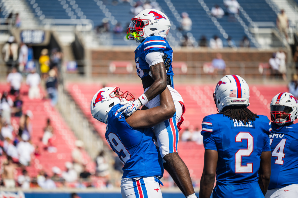 SMU's wide receiver Derrick McFall (0) and SMU's offensive lineman PJ Williams celebrate a touchdown during a football game against UC Davis in Dallas, Saturday, Sept. 12, 2026. (AP Photo/Jessica Tobias)