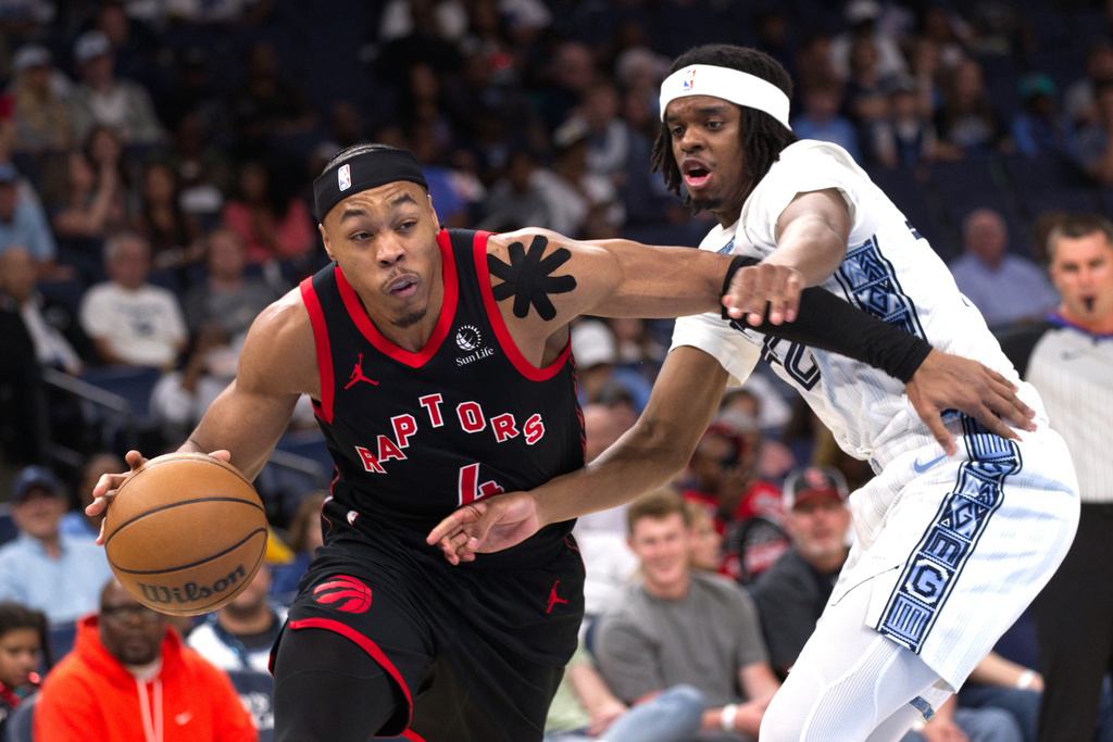 Toronto Raptors forward Scottie Barnes, left, drives to the basket while defended by Memphis Grizzlies guard Adama Bal, right, during the first half of an NBA basketball game Friday, April 3, 2026, in Memphis, Tenn. (AP Photo/Nikki Boertman)