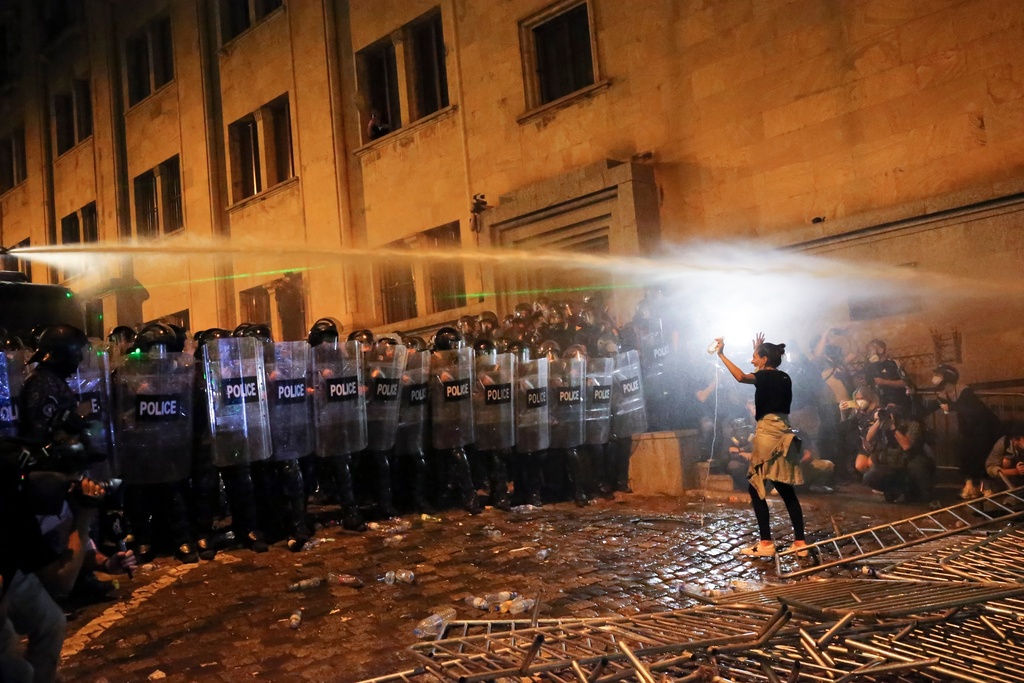 FILE - A demonstrator gestures trying to stop riot police during a protest near the parliament building in Tbilisi, Georgia, on Tuesday, April 30, 2024. (AP Photo/Zurab Tsertsvadze, File)