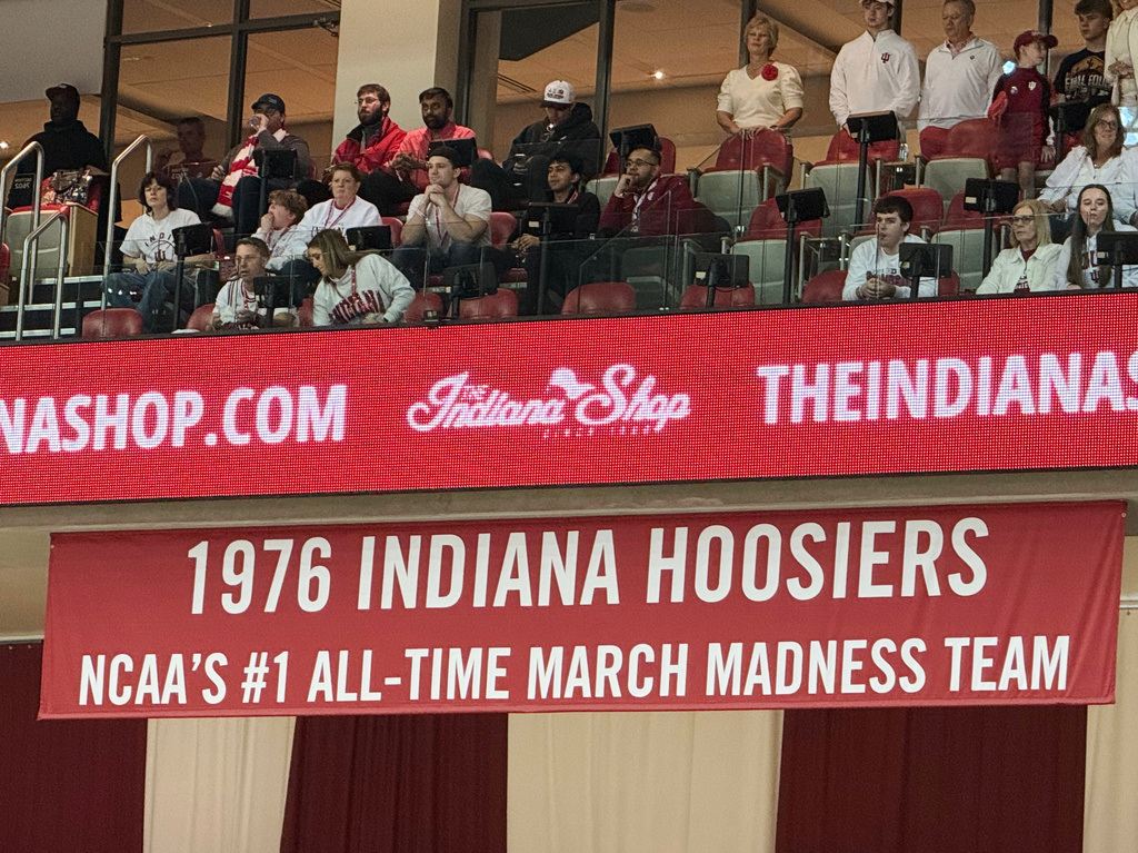 A banner marking the Indiana Hoosiers 1975-76 national championship team, the last undefeated men's Division I team to win the championship, hangs in the arena before a basketball game against Michigan State, March 1, 2026, in Bloomington, Ind. (AP Photo/Mike Marot)