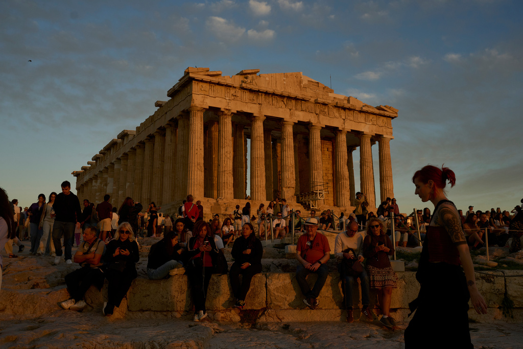 Tourists visit the Acropolis hill and the 5th century B.C. Parthenon temple in Athens, Sunday, Oct. 26, 2025. (AP Photo/Petros Giannakouris)