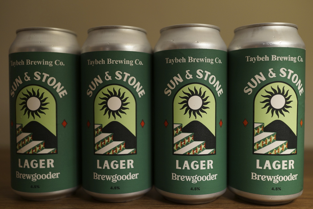 Cans of Sun & Stone lager, produced by Brewgooder in Glasgow, Scotland, in collaboration with Taybeh Brewing Co. in the Israeli-occupied West Bank, to help the struggling Palestinian beer maker, are seen in London, Monday, Sept. 8, 2025. (AP Photo/Brian Melley)
