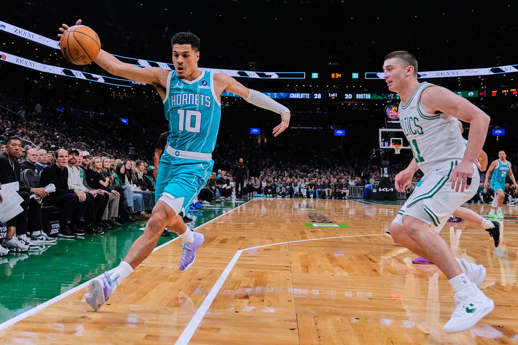 Charlotte Hornets guard Josh Green (10) grabs a loose ball against Boston Celtics guard Payton Pritchard (11) during the first half of a NBA basketball game, Tuesday, April 7, 2026, in Boston. (AP Photo/Charles Krupa)
