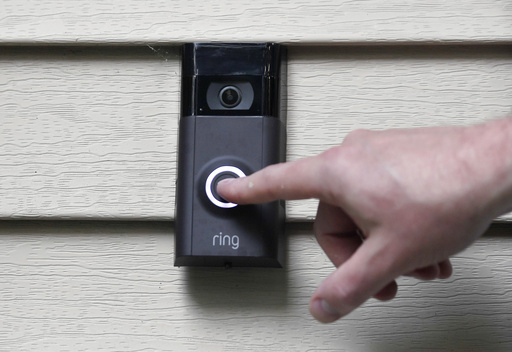 FILE - A person pushes the doorbell on his Ring doorbell camera, July 16, 2019, at his home in Wolcott, Conn. The Federal Trade Commission is sending $5.6 million in refunds to consumers as part of a settlement with Amazon-owned Ring, which was charged with failing to protect private video footage from outside access. (AP Photo/Jessica Hill, File)