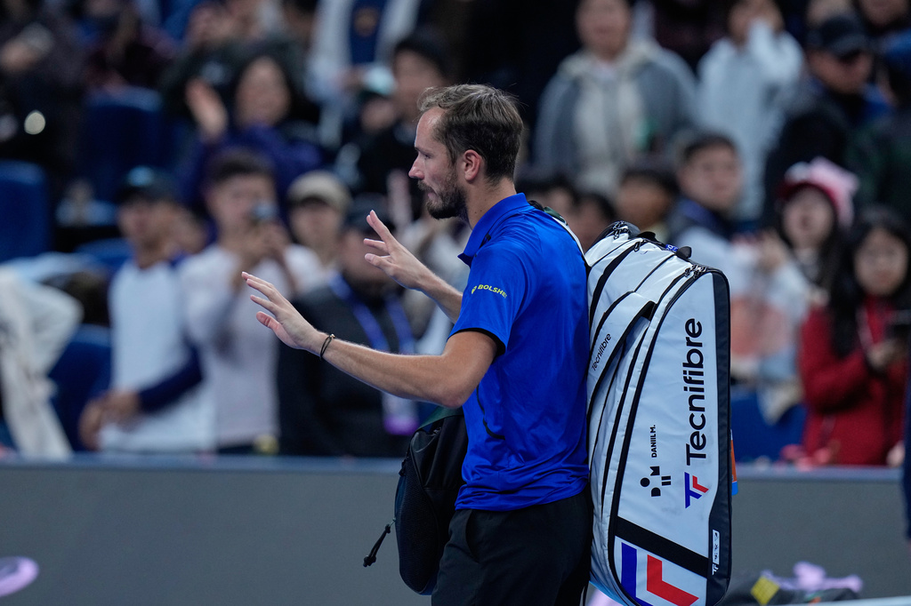Daniil Medvedev, of Russia, leaves the court after being disqualified during a semi final match against Novak Djokovic, of Serbia at the China Open tennis tournament in Beijing, Monday, Oct. 5, 2026. (AP Photo/Andy Wong)