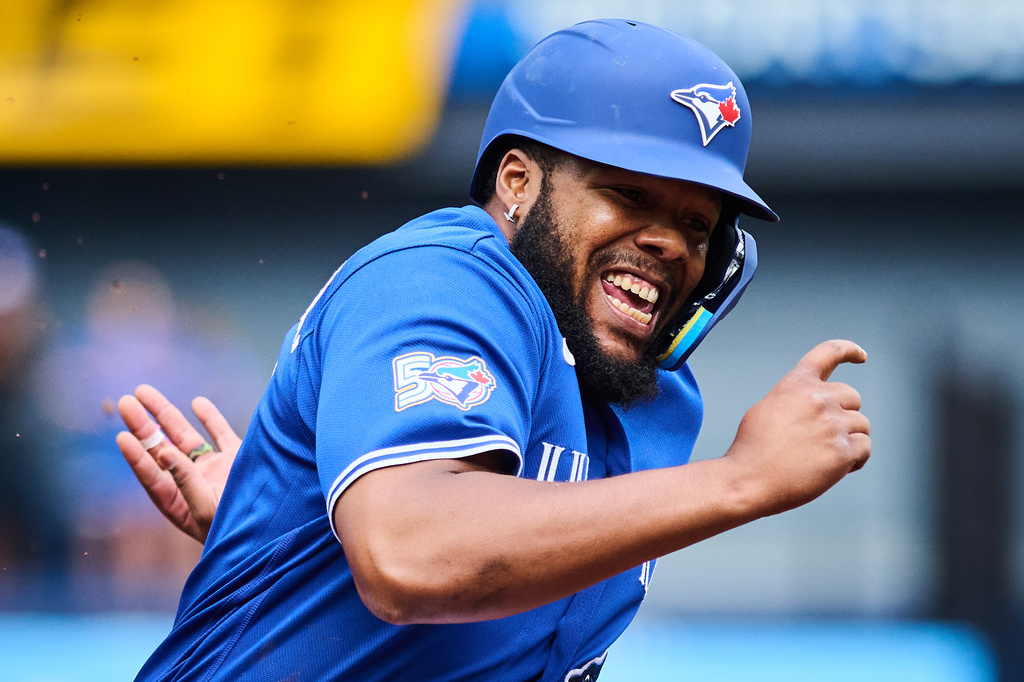Toronto Blue Jays' Vladimir Guerrero Jr. (27) sprints in to score on a single by Alejandro Kirk (30), not shown, during first inning a baseball game against the Baltimore Orioles in Toronto, on Saturday, Sept. 12, 2026. (Sammy Kogan/The Canadian Press via AP)