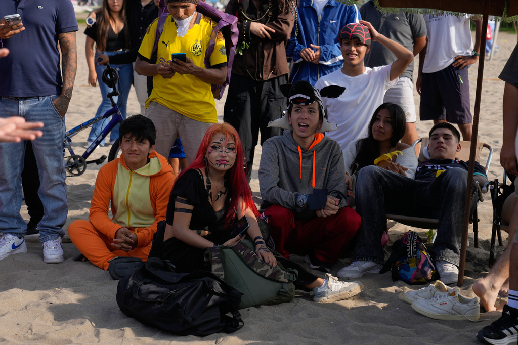 Aura farmers wait their turn to compete in aura-farming battles at Las Sombrilla beach in Lima, Peru, on Aug. 29, 2026. (AP Photo/Martin Mejia)