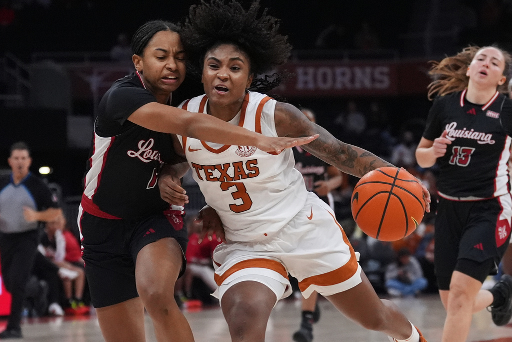 Texas guard Rori Harmon (3) drives to the basket against Louisiana Lafayette guard Kahlen Norris (1) during the second half of an NCAA college basketball game in Austin, Texas, Monday, Nov. 10, 2025. (AP Photo/Eric Gay)