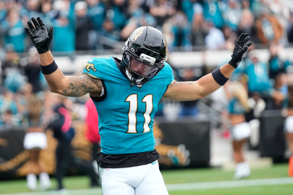 Jacksonville Jaguars wide receiver Parker Washington (11) celebrates his touchdown during the first half of an NFL football game against the Tennessee Titans, Sunday, Jan. 4, 2026, in Jacksonville, Fla. (AP Photo/John Raoux)