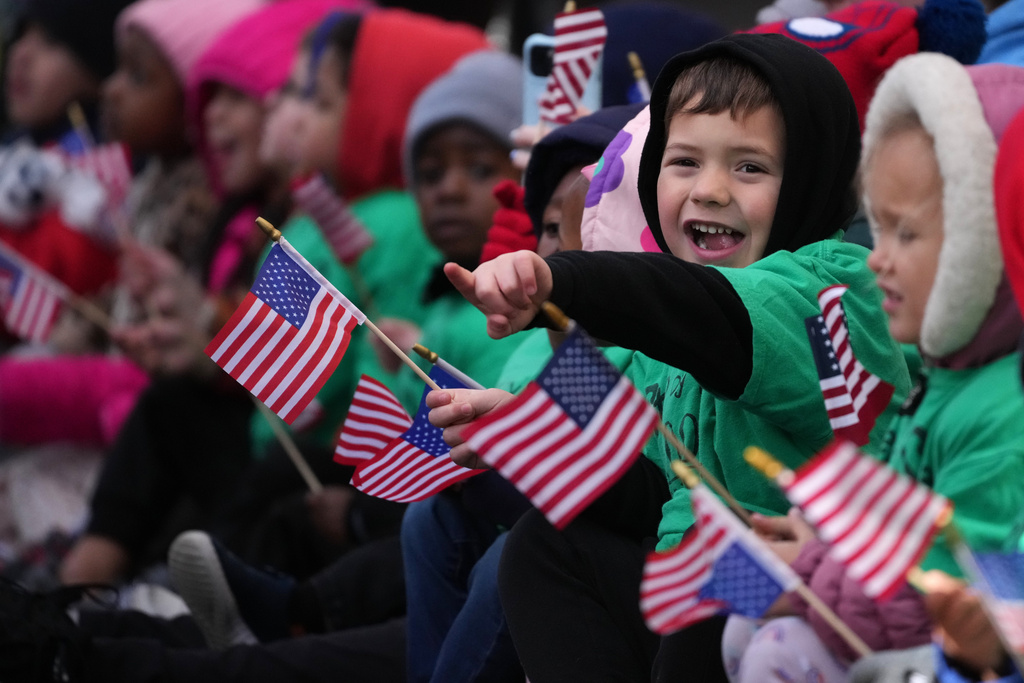 Children watch a Veterans Day Parade, Tuesday, Nov. 11, 2025, in Media, Pa. (AP Photo/Matt Slocum)