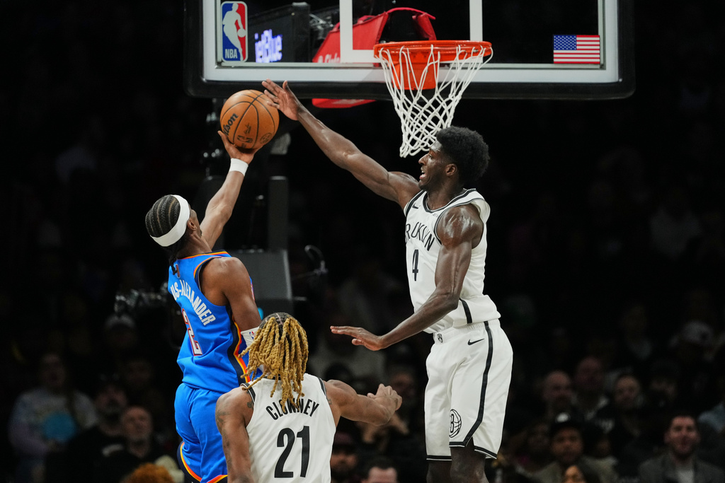Brooklyn Nets' Drake Powell (4) defends a shot by Oklahoma City Thunder's Shai Gilgeous-Alexander (2) during the first half of an NBA basketball game Wednesday, March 18, 2026, in New York. (AP Photo/Frank Franklin II)