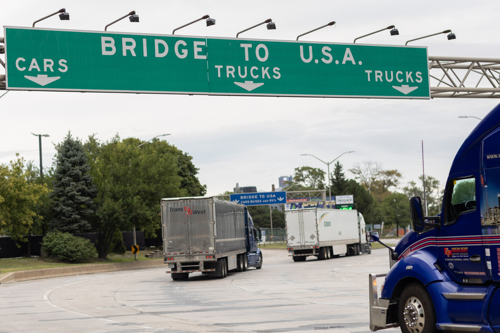 Transport trucks cross the Ambassador Bridge into the United States of America, in Windsor, Ontario, Canada, Saturday, Aug. 22, 2026. (Dax Melmer/The Canadian Press via AP)