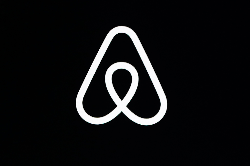 FILE - An Airbnb logo is displayed at an event in San Francisco on Feb. 22, 2018. (AP Photo/Eric Risberg, File)