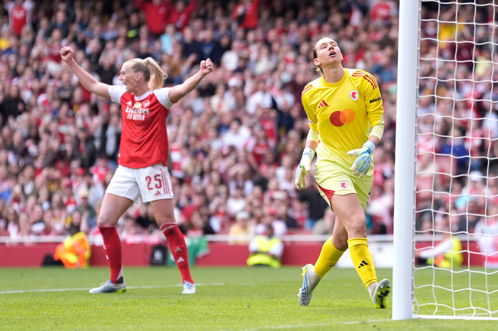 OL Lyonnes' goalkeeper Christiane Endler, right, reacts as Arsenal's Stina Blackstenius, left, celebrates her side's first goal during the Women's Champions League semi-final, first leg soccer match between Arsenal and OL Lyonnes in London, England, Sunday April 26, 2026. (Andrew Matthews/PA via AP)