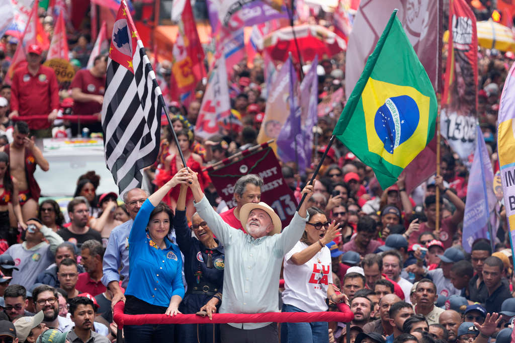 President Luiz Inacio Lula da Silva, who is running for reelection, waves a Brazilian and Sao Paulo state flags during a campaign rally a day ahead of the country's general election in Sao Paulo, Saturday, Oct. 3, 2026. (AP Photo/Andre Penner)