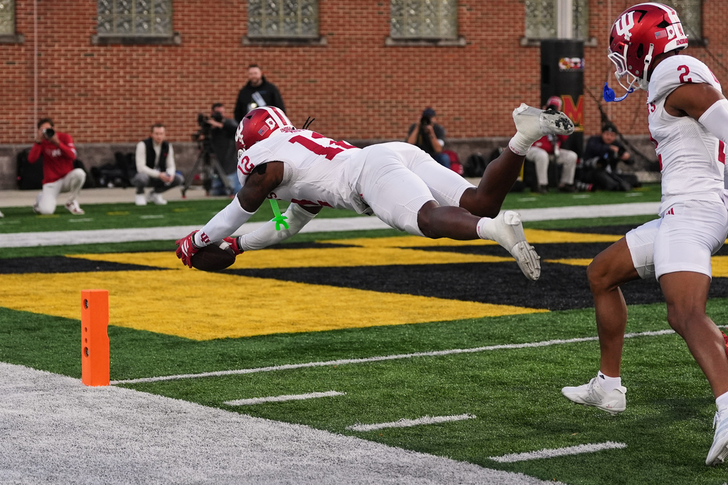 Indiana defensive back Devan Boykin (12) dives over the goal line as he returns a fumble for a touchdown during the second half of an NCAA college football game against Maryland, Saturday, Nov. 1, 2025, in College Park, Md. (AP Photo/Stephanie Scarbrough)