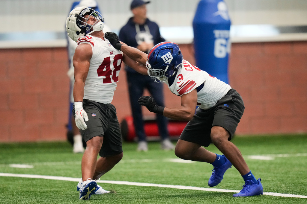 New York Giants' Abdul Carter, right, and Trace Ford participate in a drill during NFL football practice in East Rutherford, N.J., Thursday, May 21, 2026. (AP Photo/Seth Wenig)