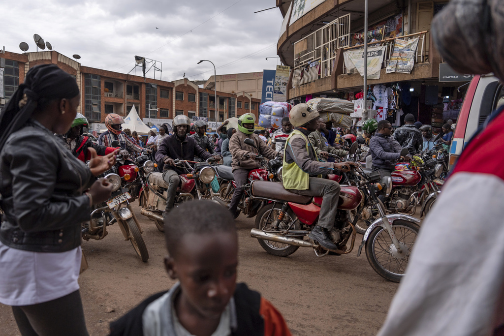 Motorcyclists crowd a busy shopping street, Saturday, Nov. 23, 2024, in Kampala, Uganda, home to one of the world's youngest populations, where half of its people are under 18 years old. (AP Photo/David Goldman)