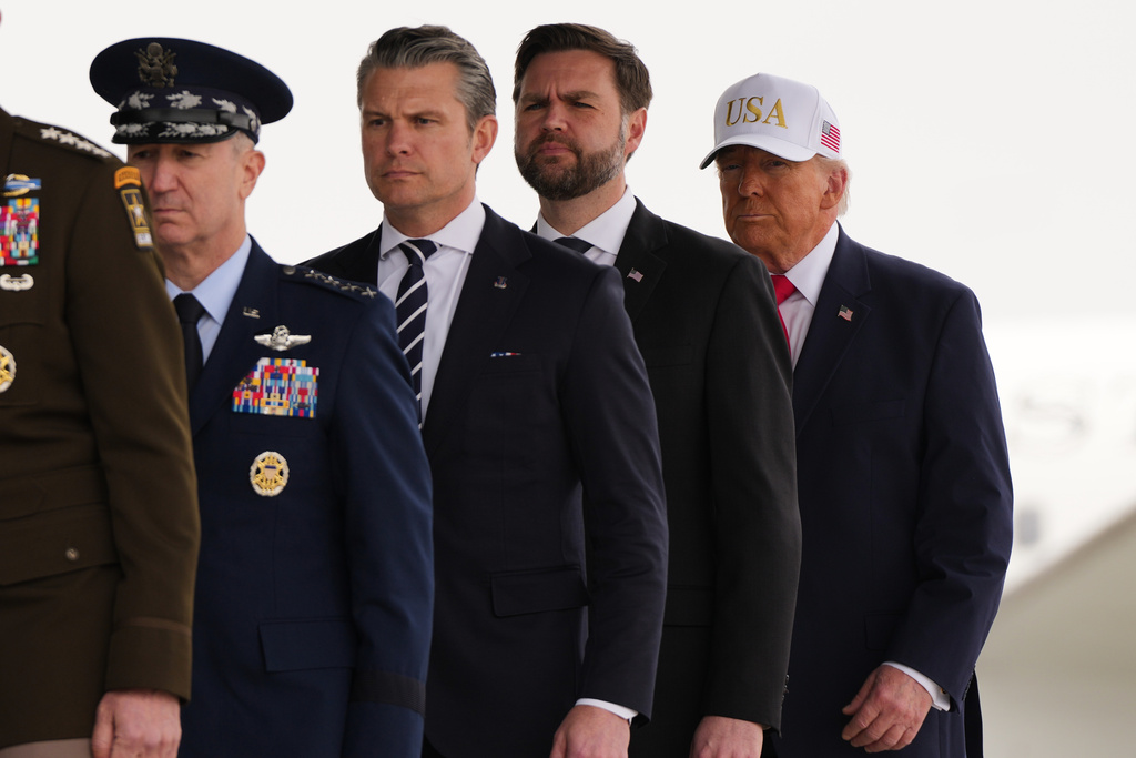 President Donald Trump, from right, Vice President JD Vance, Defense Secretary Pete Hegseth, Chairman of the Joint Chiefs of Staff Gen. Dan Caine, walk after a prayer during a casualty return for the six U.S. Army Reserve soldiers who were killed in a drone strike at a command center in Kuwait after the U.S. and Israel launched its military campaign against Iran, during a casualty return Saturday, March 7, 2026, at Dover Air Force Base, Del. (AP Photo/Julia Demaree Nikhinson)