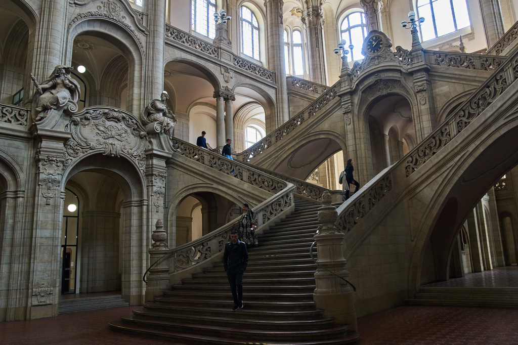 People walk in the court on the day of the trial against an online predator network of men accused of using chat groups to share tips on how to drug and rape women, in Berlin, Germany, Wednesday, July 8, 2026. (AP Photo/Ebrahim Noroozi)