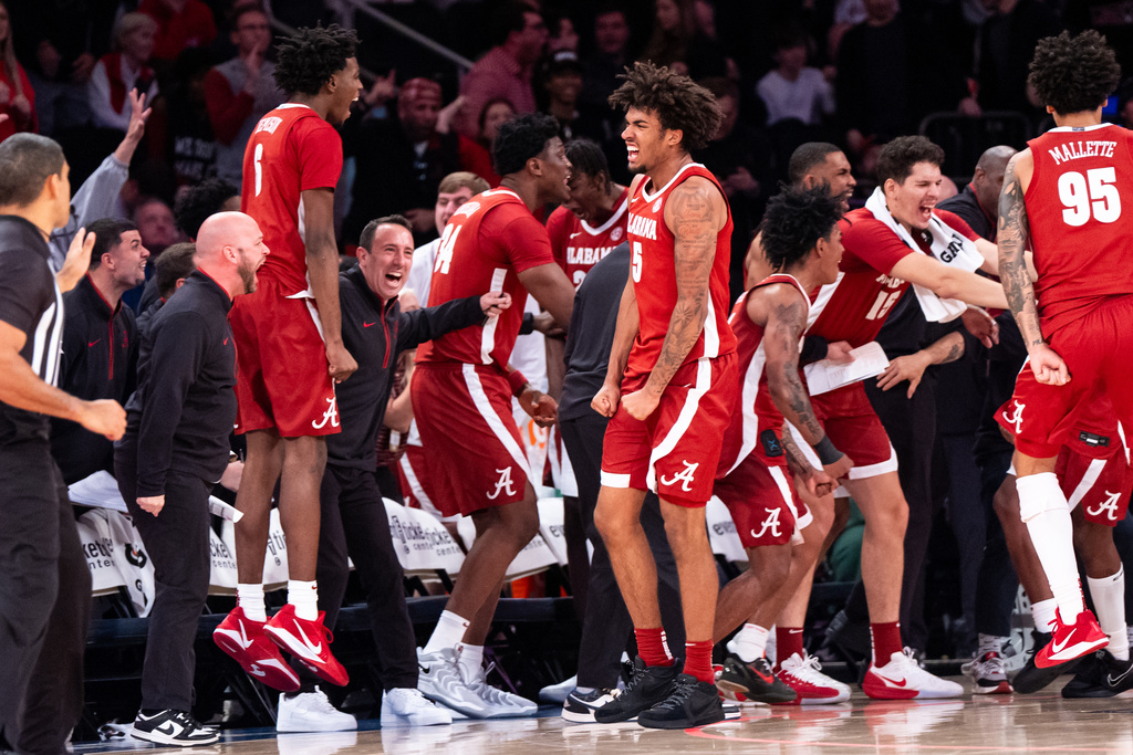 Alabama forward Amari Allen (5) and teammates celebrate a basket near the end of the second half of an NCAA college basketball game against St. John's, Saturday, Nov. 8, 2025, in New York. (AP Photo/Angelina Katsanis)