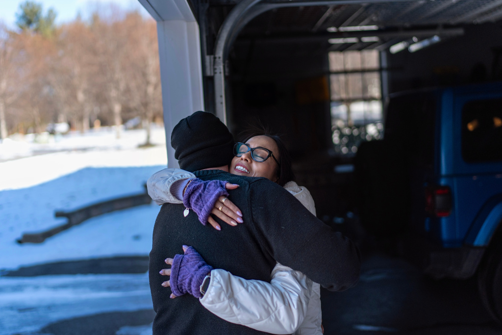 Ruth Wilson, right, embraces her husband, Jim, before leaving for her monthly lupus-focused IV treatment, Tuesday, Jan. 14, 2025, in Littleton, Mass. (AP Photo/David Goldman)