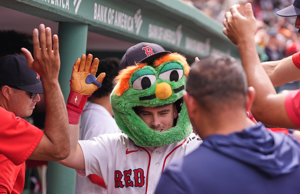 Boston Red Sox's Caleb Durbin is congratulated after his solo home run in the eighth inning of a baseball game against the Toronto Blue Jays', Thursday, June 18, 2026, in Boston. (AP Photo/Charles Krupa)