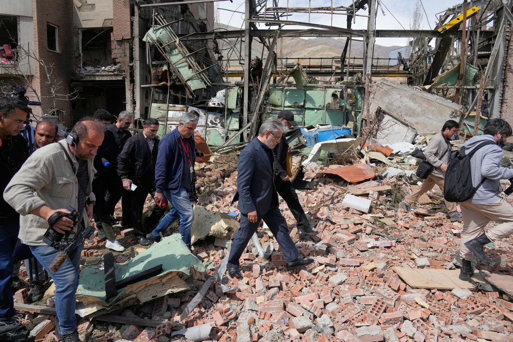 Iran's Minister of Science, Research and Technology Hossein Simaei Sarraf, center, visits the location that was hit during U.S.-Israeli airstrikes Friday at Shahid Beheshti University in Tehran, Iran, Saturday, April 4, 2026. (AP Photo/Vahid Salemi)