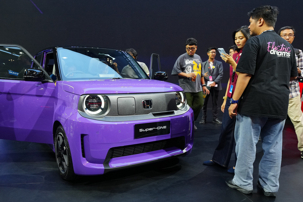 Visitors examine a Honda Super-One EV during the Indonesia International Auto Show organized by the Association of Indonesian Automotive Industries (GAIKINDO) in Tangerang, Indonesia, Thursday, July 30, 2026. (AP Photo/Tatan Syuflana)