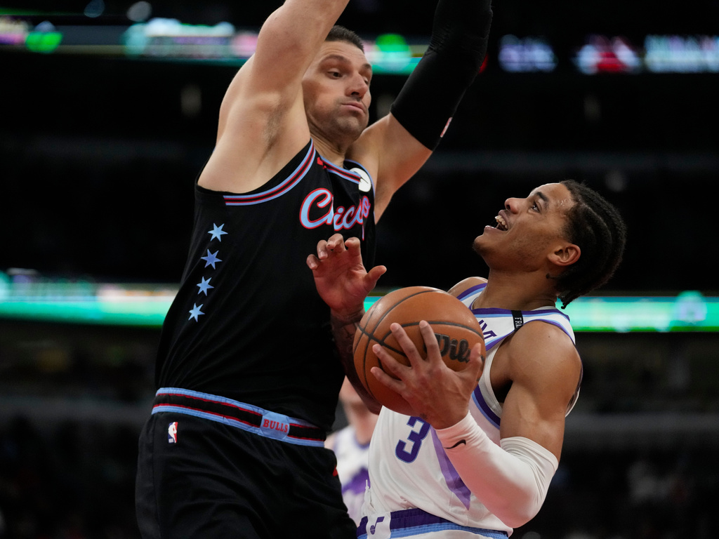 Chicago Bulls center Nikola Vucevic (9), left, fouls Utah Jazz during the second half of an NBA basketball game Wednesday, Jan. 14, 2026, in Chicago. (AP Photo/Erin Hooley)