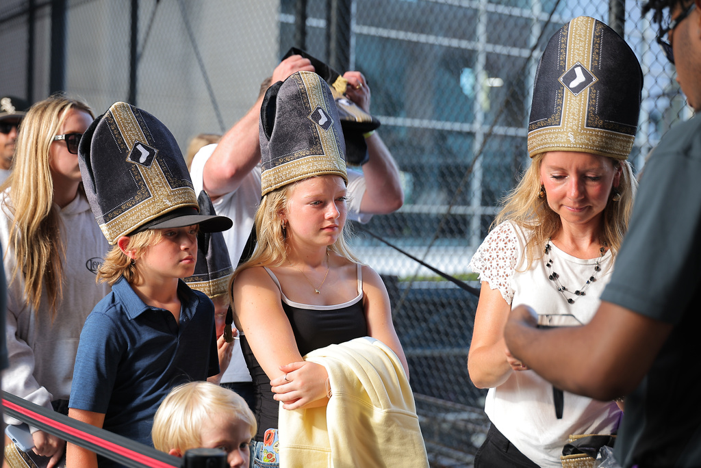 A group of fans wore a promotional Pope hat prior to a baseball game between the Cincinnati Reds and Chicago White Sox, Tuesday, Aug. 11, 2026, in Chicago. (AP Photo/Melissa Tamez)