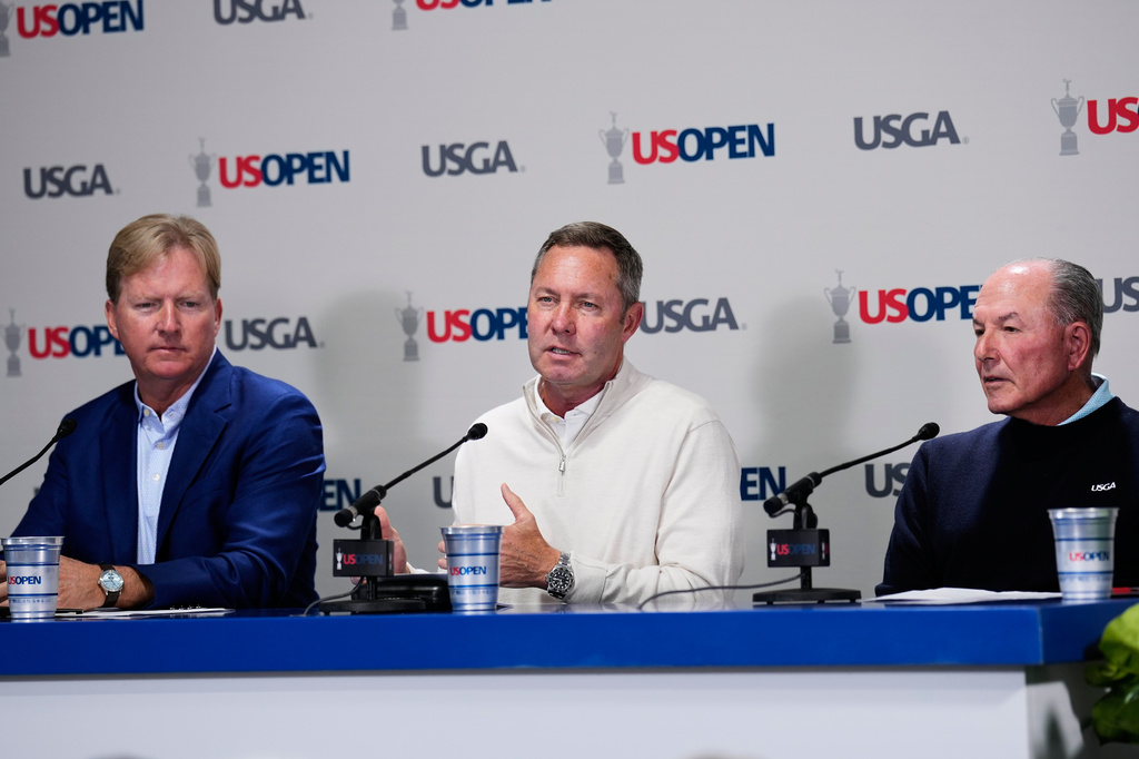 From left, United States Golf Association's President Kevin Hammeron, CEO Mike Whan and chief championships officer John Bodenhamer speak during a news conference during the U.S. Open golf tournament at Shinnecock Hills Golf Club in Southampton, N.Y., Wednesday, June 17, 2026.(AP Photo/David J. Phillip)
