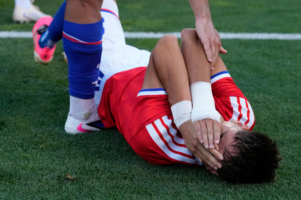 Chile's Ivan Roman covers his face during an international friendly soccer match between Portugal and Chile in Oeiras, outside Lisbon, Saturday, June 6, 2026. (AP Photo/Armando Franca)
