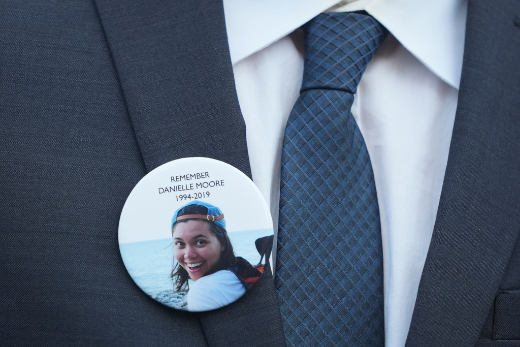 FILE - A family member wears a photo of Boeing crash victim Danielle Moore before a hearing at federal court in Fort Worth, Texas, Sept. 3, 2025. (AP Photo/LM Otero, File)