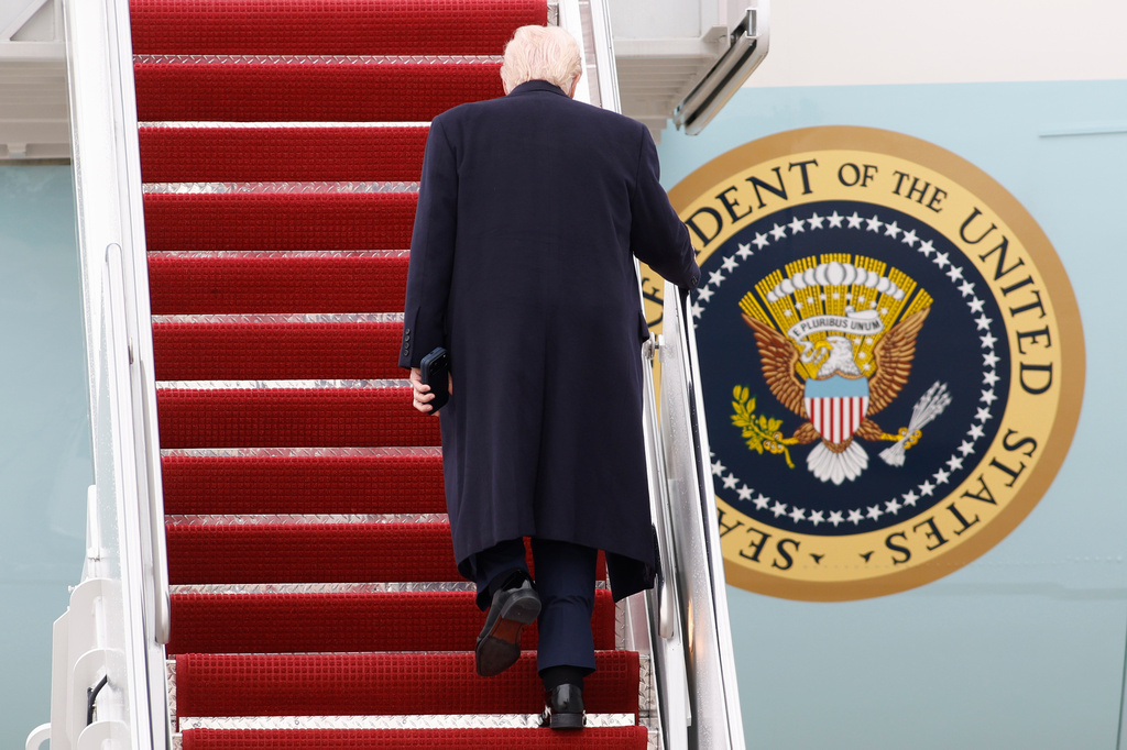 President Donald Trump walks up the stairs of Air Force One at Joint Base Andrews, Md., Friday, March 27, 2026. (AP Photo/Luis M. Alvarez)