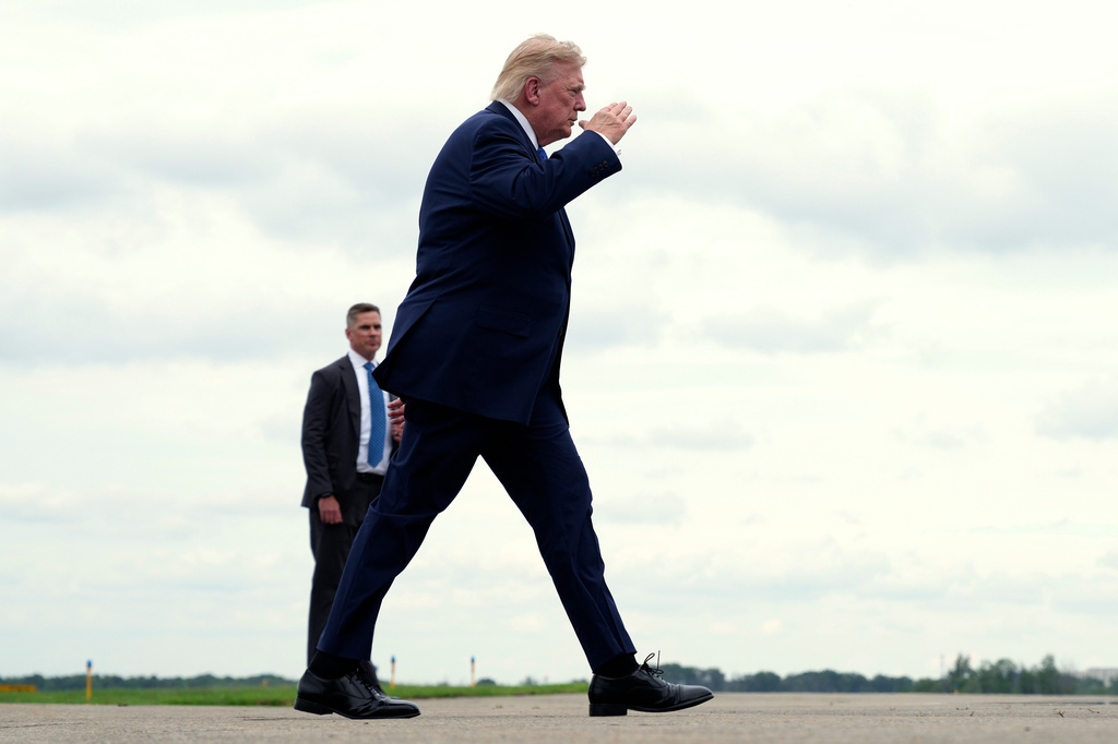 President Donald Trump walks to board Air Force One at Morristown Municipal Airport, in Morristown, N.J., Sunday, Aug. 2, 2026, en route to return to Washington. (AP Photo/Jacquelyn Martin)