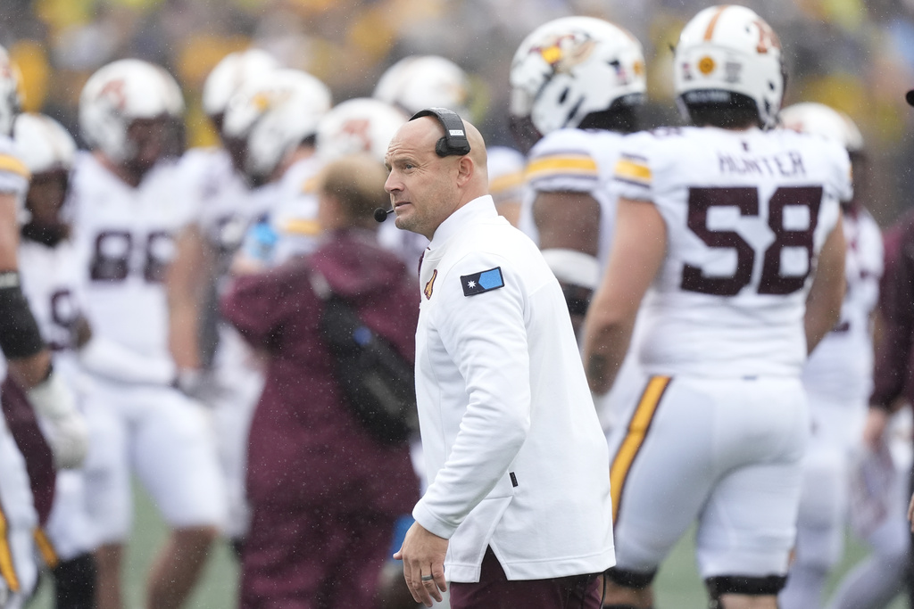 FILE - Minnesota head coach P.J. Fleck walks the sideline during the first half of an NCAA college football game against Michigan, Sept. 28, 2024, in Ann Arbor, Mich. (AP Photo/Carlos Osorio)