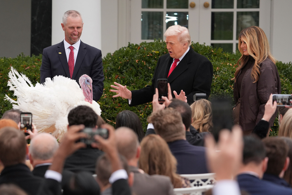 President Donald Trump and first lady Melania Trump, stand next to national Thanksgiving turkey Gobble during a pardoning ceremony in the Rose Garden of the White House, Tuesday, Nov. 25, 2025, in Washington. (AP Photo/Evan Vucci)