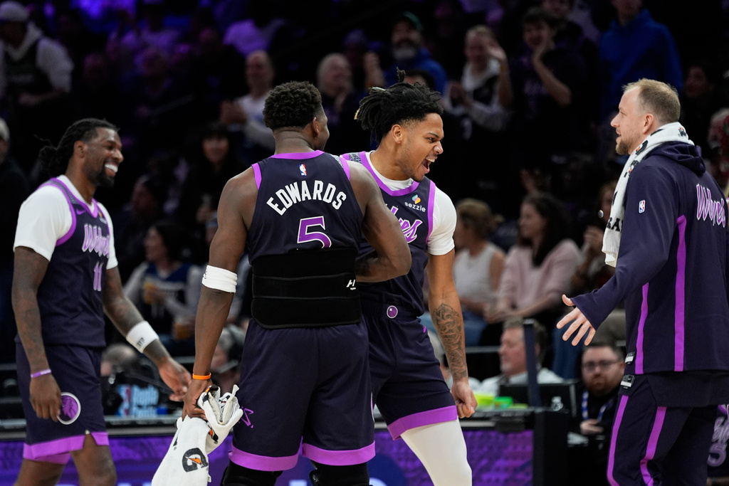 Minnesota Timberwolves guard Terrence Shannon Jr. (1), back, celebrates after making a 3-point shot during the second half of an NBA basketball game against the Milwaukee Bucks, Sunday, Dec. 21, 2025, in Minneapolis. (AP Photo/Abbie Parr)
