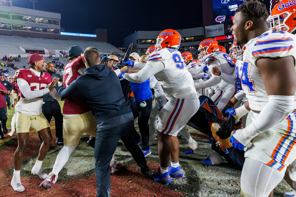 FILE -Florida State and Florida players scuffle at midfield after an NCAA college football game, Nov. 30, 2024, in Tallahassee, Fla. (AP Photo/Colin Hackley, File)
