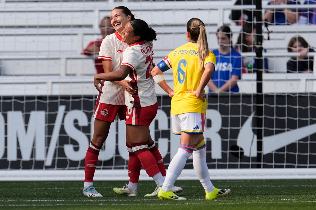 Canada defender Sydney Collins, left, celebrates her goal with midfielder Marie-Yasmine Alidou, center, during the second half of a SheBelieves Cup women's soccer tournament match Sunday, March 1, 2026, in Nashville, Tenn. (AP Photo/George Walker IV)