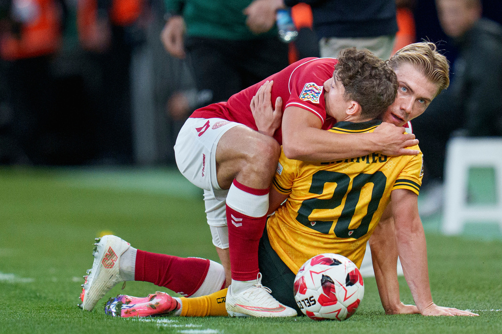 Denmark's Rasmus Hoejlund and Wales' Daniel James, back to camera, embrace during a Nations League soccer match between Denmark and Wales, in Copenhagen, Sunday, Sept. 27, 2026. (Liselotte Sabroe/Ritzau Scanpix via AP)
