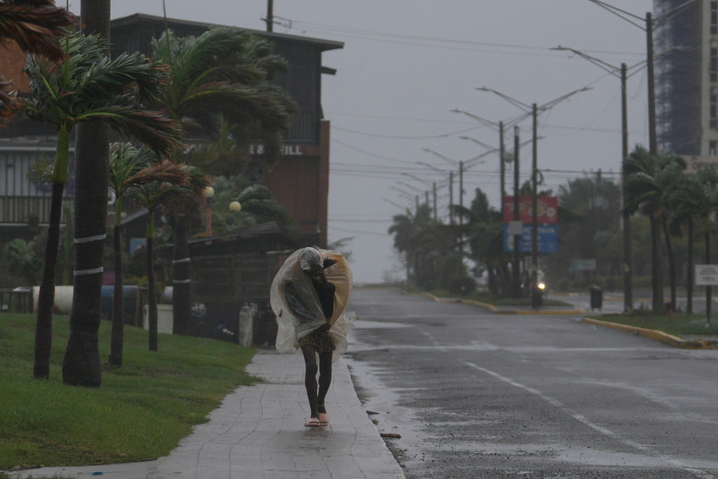 A man walks in Kingston, Jamaica, as Hurricane Melissa approaches, Tuesday, Oct. 28, 2025. (AP Photo/Matias Delacroix)