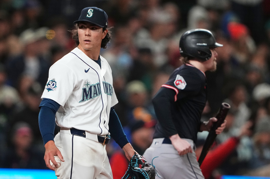 Seattle Mariners starting pitcher Bryan Woo reacts after allowing a run against the Cleveland Guardians during the sixth inning of a baseball game, Saturday, March 28, 2026, in Seattle. (AP Photo/Lindsey Wasson)