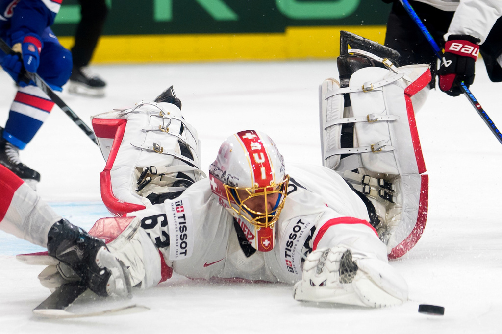 Switzerland's goaltender Leonardo Genoni reaches for the puck during a Group A preliminary round game between United States and Switzerland at the men's ice hockey world championship in Zurich, Switzerland, Friday, May 15, 2026. (Claudio Thoma/Keystone via AP)