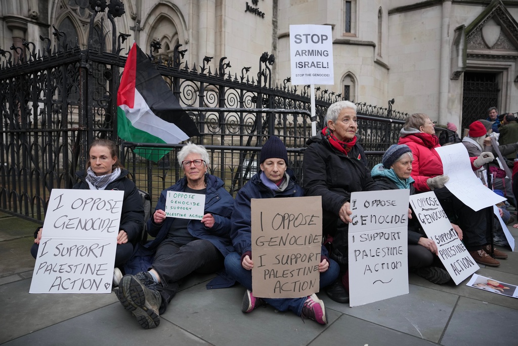 Supporters of Palestine Action stage a protest outside the Royal Court of Justice in London, Friday, Feb. 13, 2026. (AP Photo/Kin Cheung)