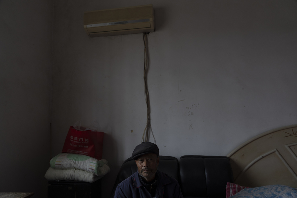 Petitioner Yang Guoliang rests in his bedroom in Changzhou in eastern China's Jiangsu Province, Friday, Dec. 13, 2024. (AP Photo/Ng Han Guan)
