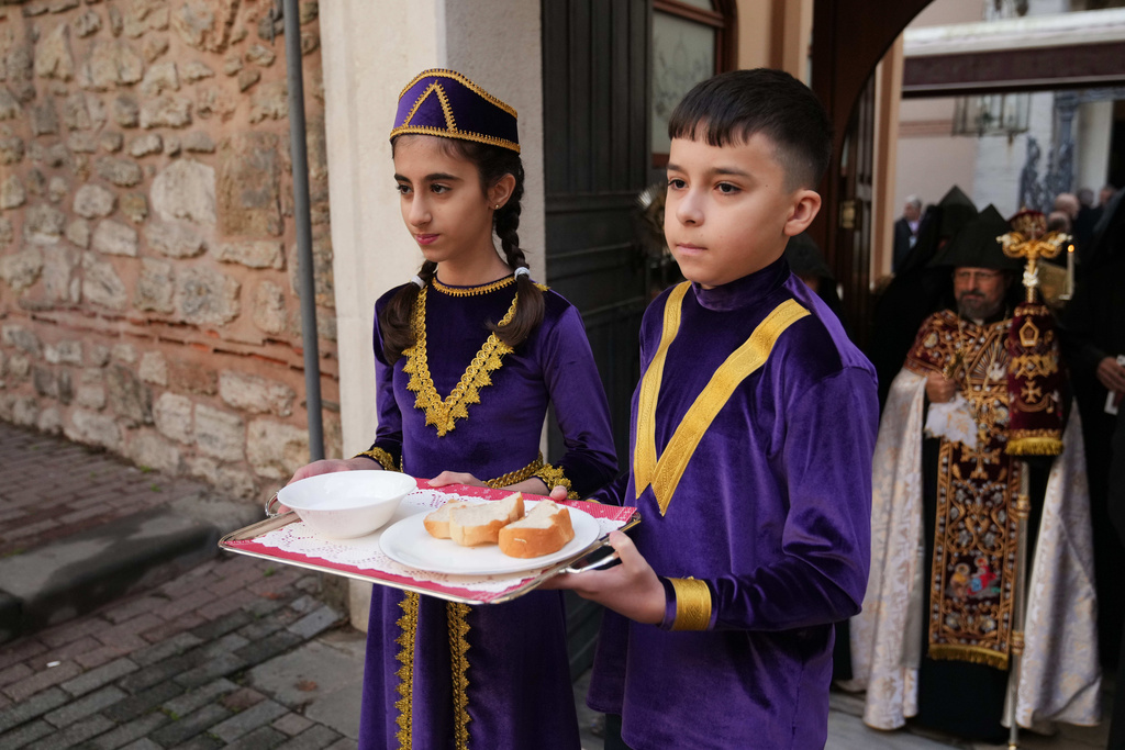 Children and Armenian Patriarch of Constantinople Archbishop Sahag II Mashalian, background right, wait for Pope Leo XIV to celebrate a liturgy at the Armenian Apostolic Cathedral, in Istanbul, Turkey, Sunday, Nov. 30, 2025. (AP Photo/Dilara Acikgoz)