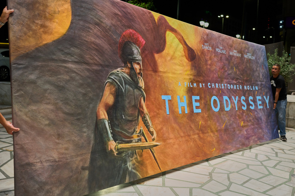 Workers install a hand-painted billboard, painted by artist Virginia Axioti, for Christopher Nolan's upcoming film "The Odyssey," starring Matt Damon as Odysseus, outside Athens' Athinaion cinema, Saturday, July 11, 2026. (AP Photo/Petros Giannakouris)
